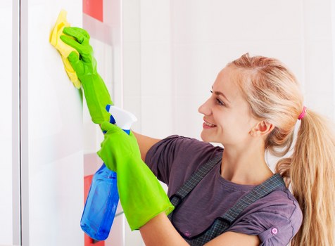 Cleaner preparing carpet cleaning equipment safely indoors